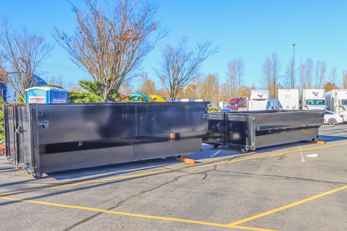 Professional dumpster rental service with roll-off container on residential driveway in Hardeeville